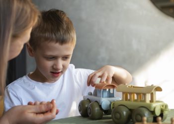 mother-playing-with-her-autistic-son-using-toys