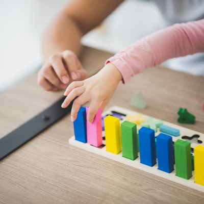 parent and girl playing Lego toddler brick blocks at home to improve life skill and education of preschool. Family leisure activity and communication